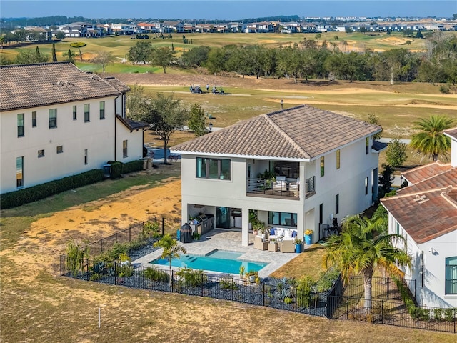 rear view of house featuring cooling unit, an outdoor hangout area, a patio, and a balcony