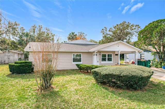 view of front of house featuring a carport and a front lawn