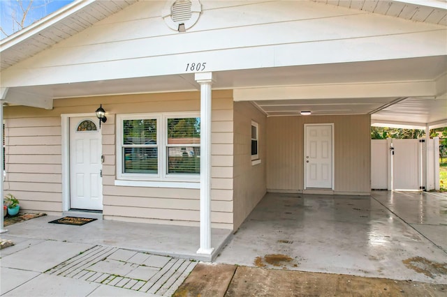 property entrance featuring a carport