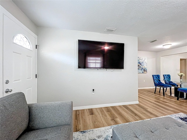 interior space with wood-type flooring and a textured ceiling