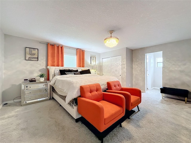 bedroom featuring a closet, a textured ceiling, and carpet