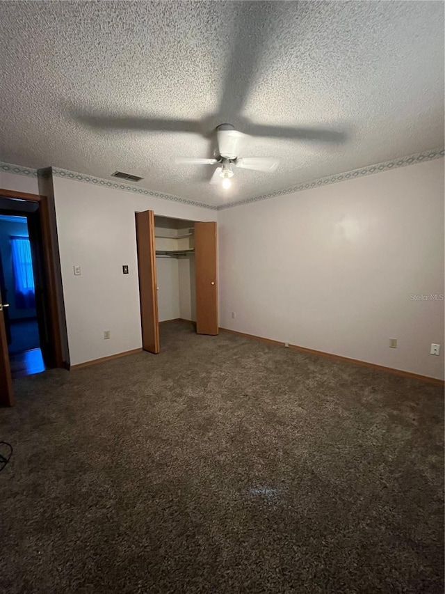 unfurnished bedroom featuring a textured ceiling, a closet, ceiling fan, and carpet flooring