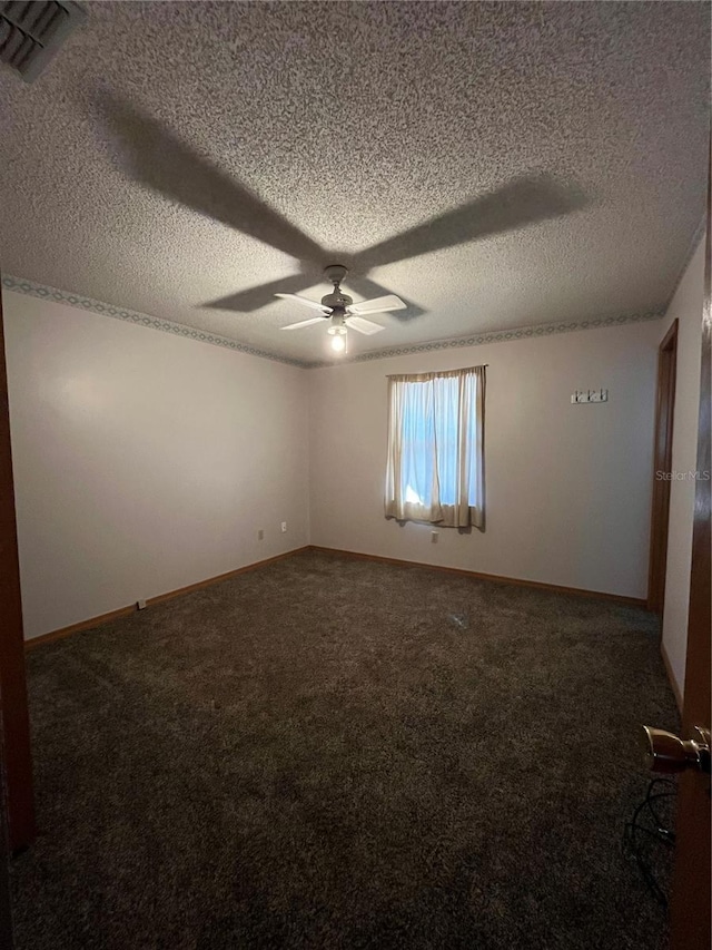 spare room with carpet floors, a textured ceiling, and ceiling fan