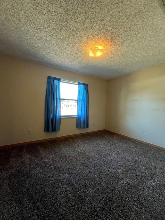 spare room with carpet and a textured ceiling