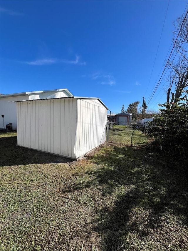 view of outbuilding with a yard