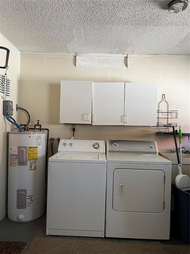 laundry room featuring cabinets, water heater, and independent washer and dryer