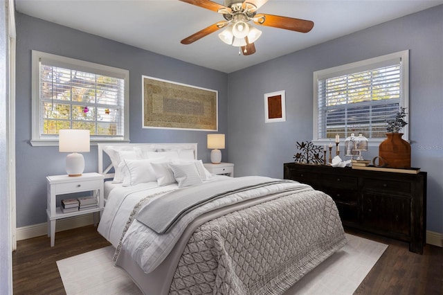 bedroom with ceiling fan and dark hardwood / wood-style flooring