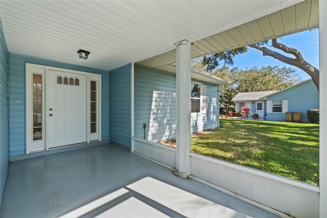 entrance to property featuring a lawn