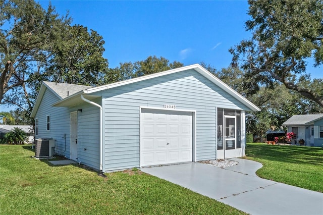 garage with a yard and central AC