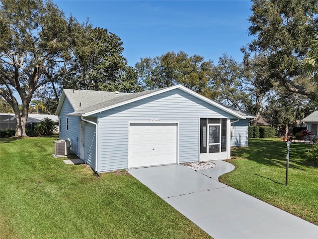 exterior space featuring a garage, central AC, and a lawn