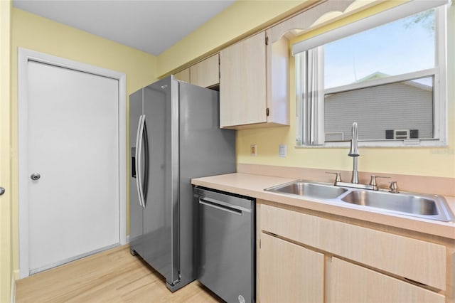 kitchen featuring appliances with stainless steel finishes, light hardwood / wood-style floors, sink, and light brown cabinets