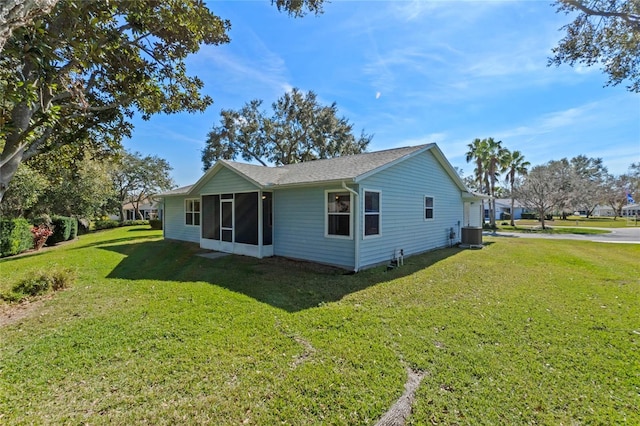 view of side of property with a yard