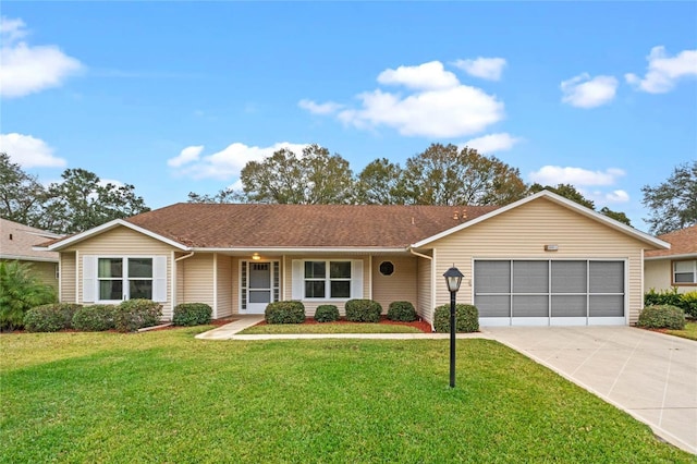 ranch-style home featuring a garage and a front lawn