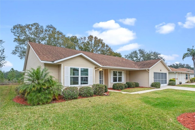 single story home featuring a garage and a front yard