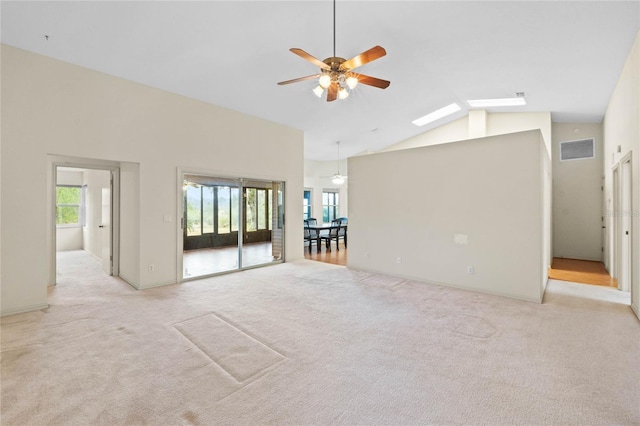 unfurnished living room featuring light carpet, high vaulted ceiling, and ceiling fan