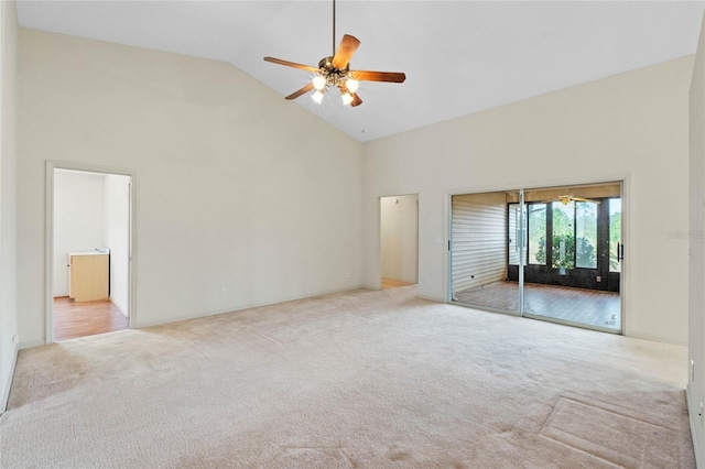 carpeted empty room featuring ceiling fan and high vaulted ceiling