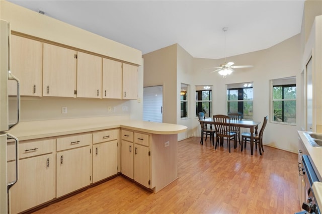 kitchen featuring light hardwood / wood-style flooring, ceiling fan, light brown cabinetry, kitchen peninsula, and white fridge