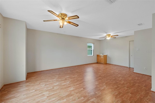 unfurnished room with ceiling fan and light wood-type flooring