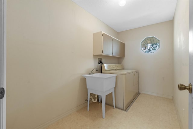 washroom featuring cabinets and washer and dryer