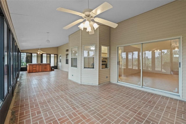 unfurnished sunroom with lofted ceiling and ceiling fan