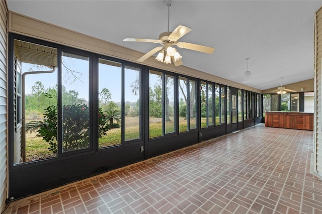 unfurnished sunroom featuring lofted ceiling and ceiling fan