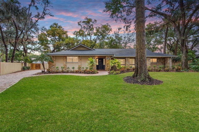 ranch-style house featuring a lawn