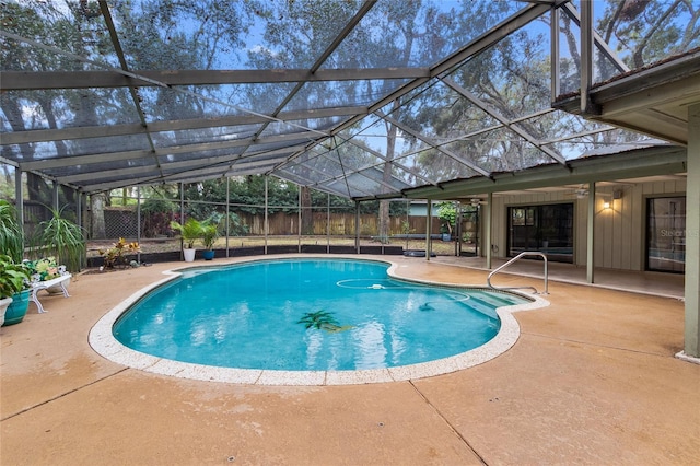 view of swimming pool featuring a lanai and a patio area