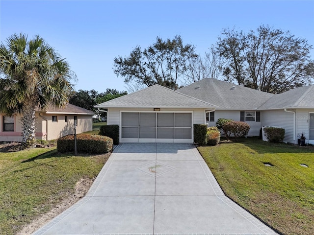 single story home featuring a garage and a front lawn