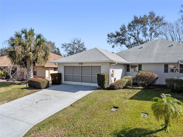 ranch-style house featuring a garage and a front yard