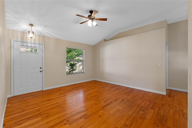 entrance foyer with light hardwood / wood-style flooring, ceiling fan, and vaulted ceiling