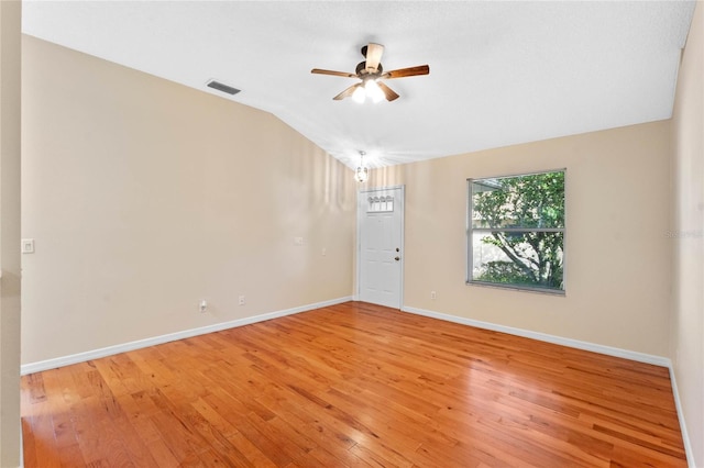 spare room with ceiling fan, lofted ceiling, and light hardwood / wood-style floors