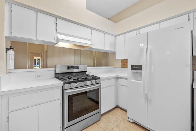 kitchen featuring light tile patterned flooring, gas stove, white cabinetry, custom range hood, and white refrigerator with ice dispenser