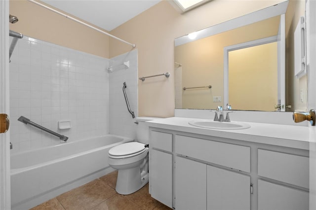 full bathroom featuring tile patterned flooring, vanity, tiled shower / bath, and toilet