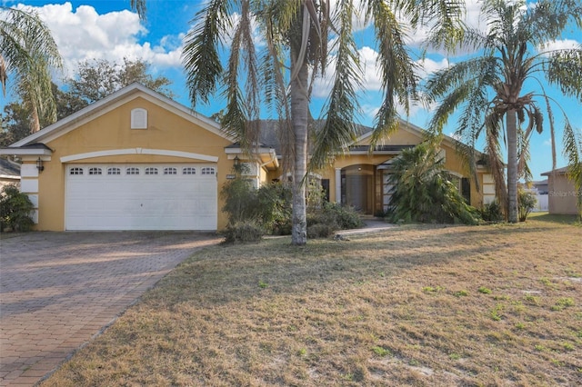 ranch-style home featuring a garage and a front yard