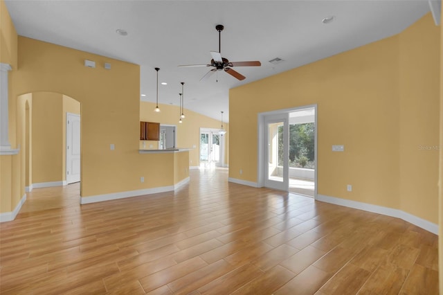 unfurnished living room with ceiling fan, vaulted ceiling, and light hardwood / wood-style floors