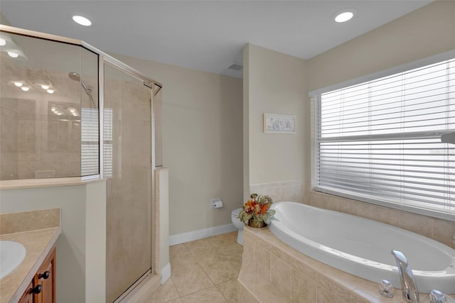 full bathroom featuring vanity, tile patterned floors, independent shower and bath, and toilet