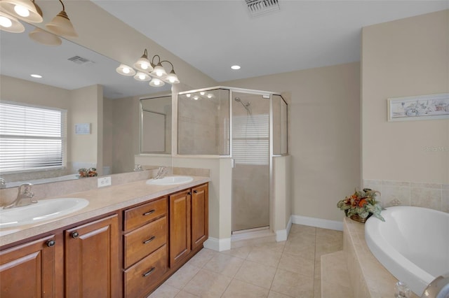 bathroom with tile patterned flooring, vanity, and shower with separate bathtub