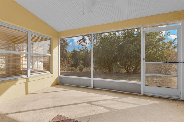 unfurnished sunroom featuring vaulted ceiling