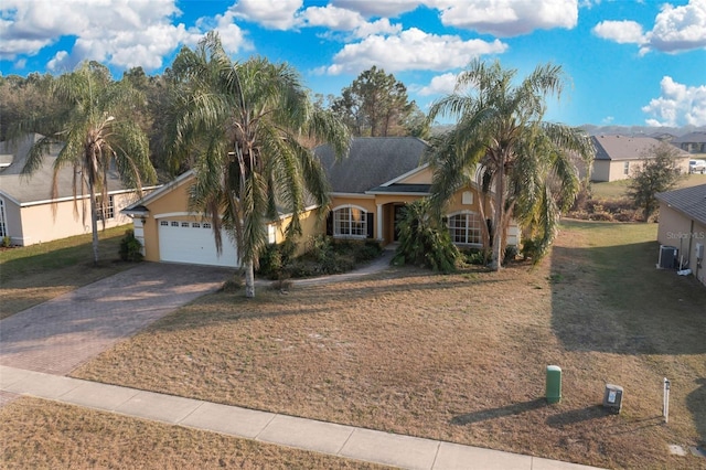 view of front of house with a garage and a front lawn