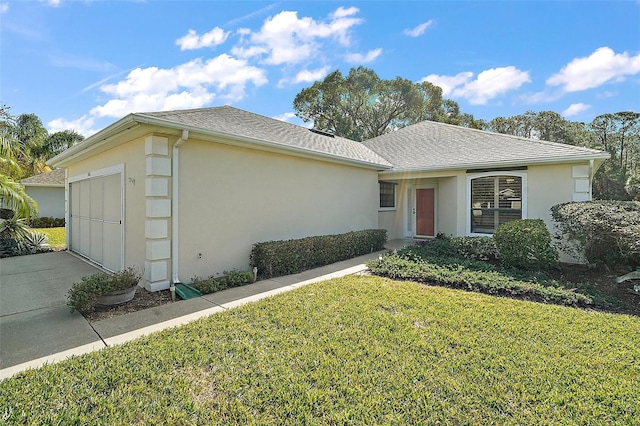 single story home featuring a garage and a front lawn