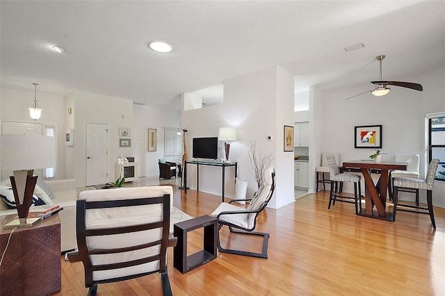 living room featuring ceiling fan and light hardwood / wood-style flooring