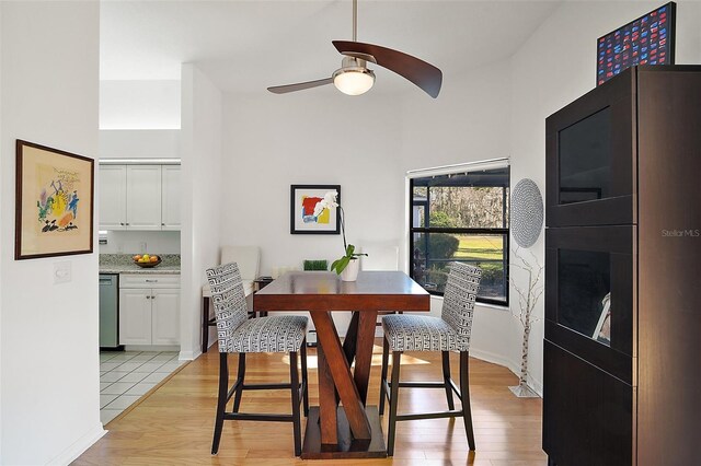 dining space featuring ceiling fan and light wood-type flooring