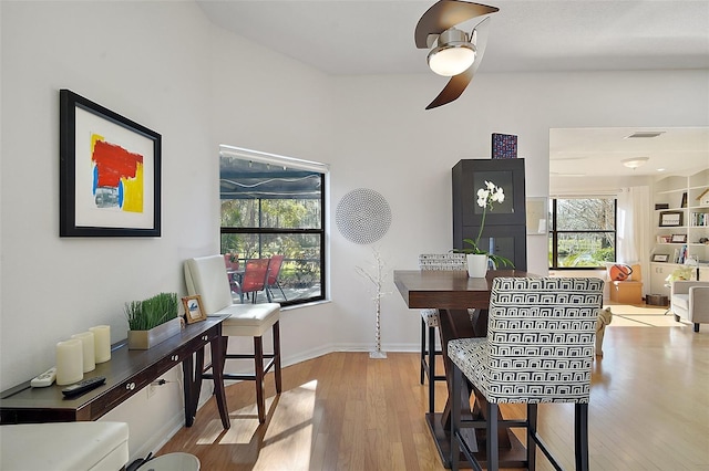 dining room with light hardwood / wood-style floors and ceiling fan