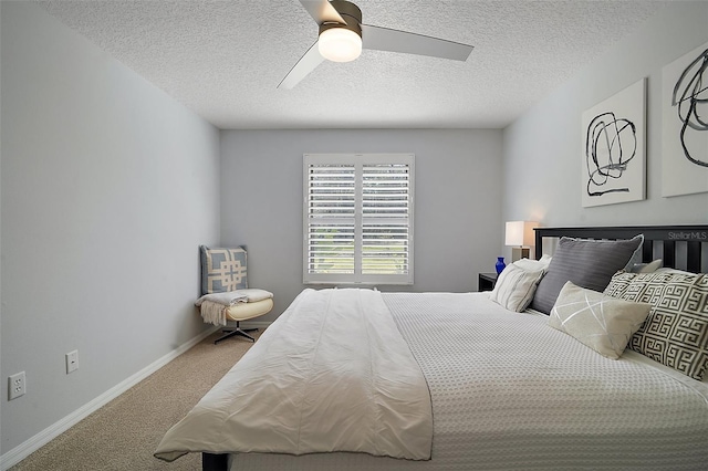 carpeted bedroom with a textured ceiling and ceiling fan