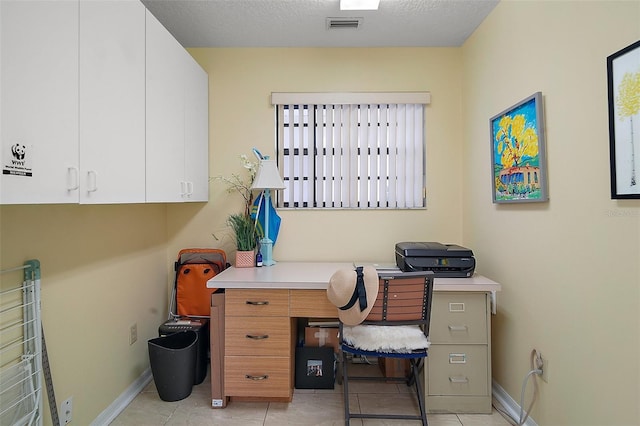 tiled office with a textured ceiling