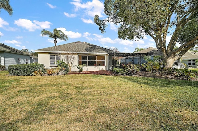 rear view of house featuring a yard