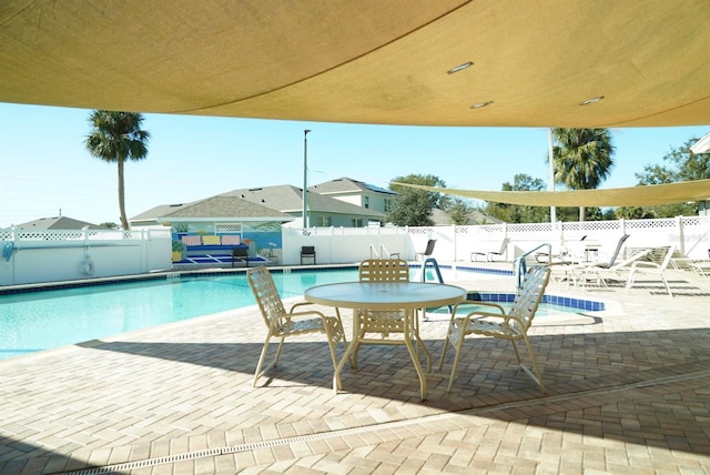 view of swimming pool featuring a patio area