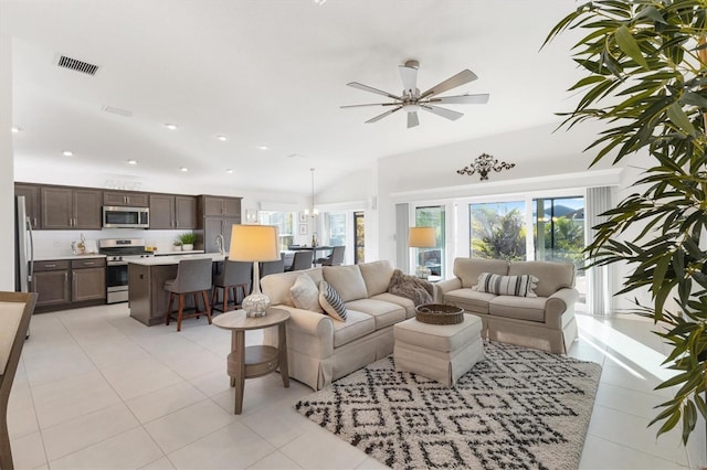 tiled living room featuring ceiling fan and sink