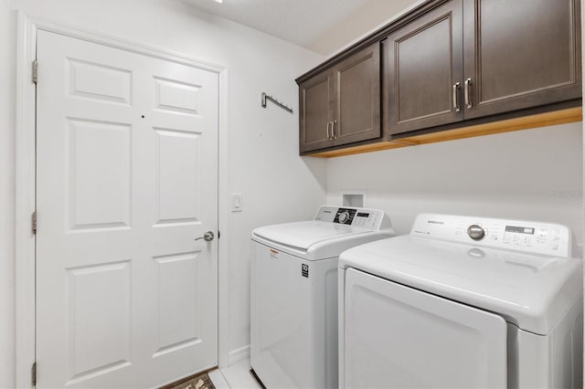 washroom featuring cabinets and separate washer and dryer