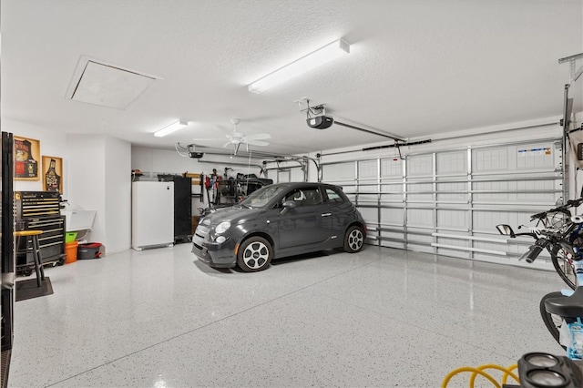 garage with a garage door opener and refrigerator